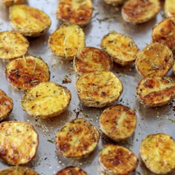 Crispy roasted potatoes on a sheet pan.