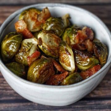 Roasted Brussels sprouts with bacon served in a small bowl.