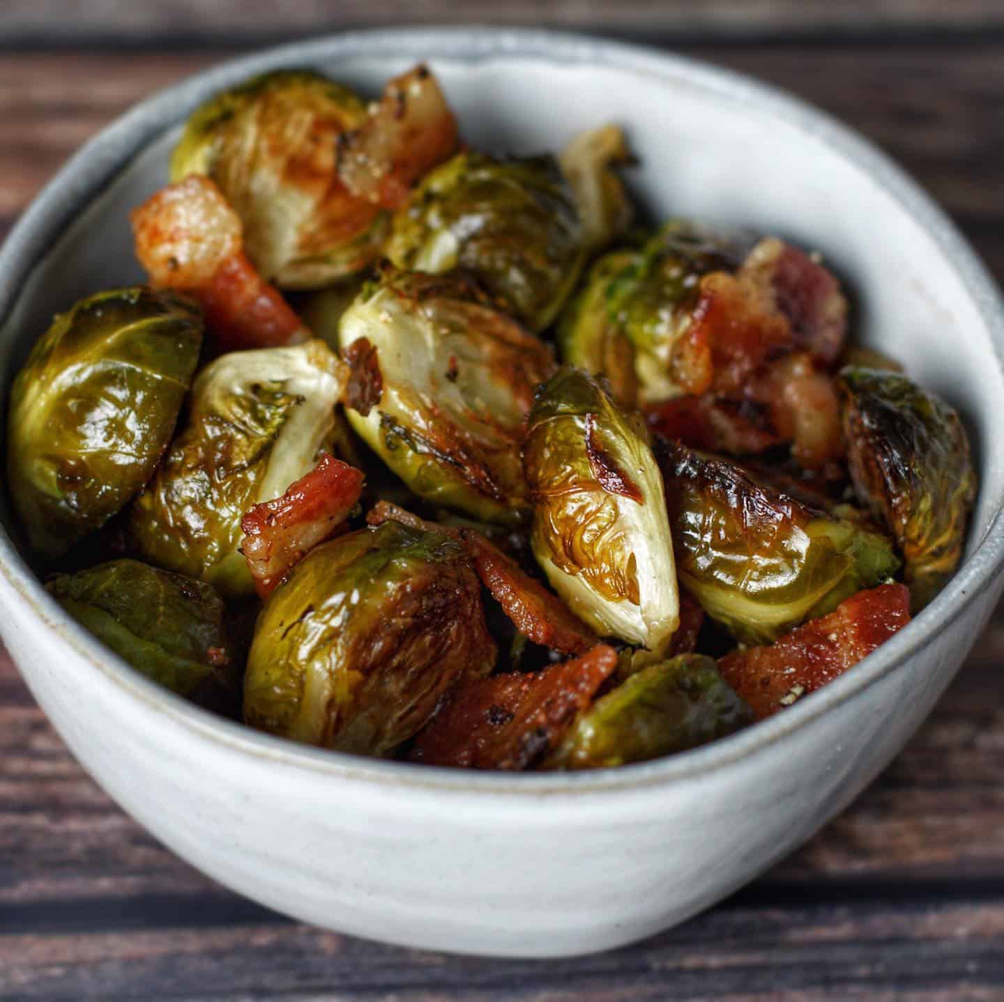 Roasted Brussels sprouts with bacon served in a small bowl.