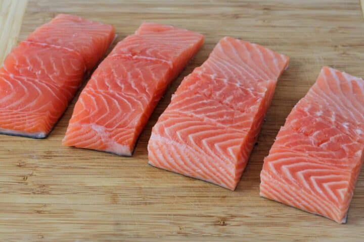 Salmon filets shown on a cutting board.