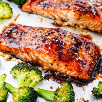 Asian glazed salmon on a pan with roasted broccoli.