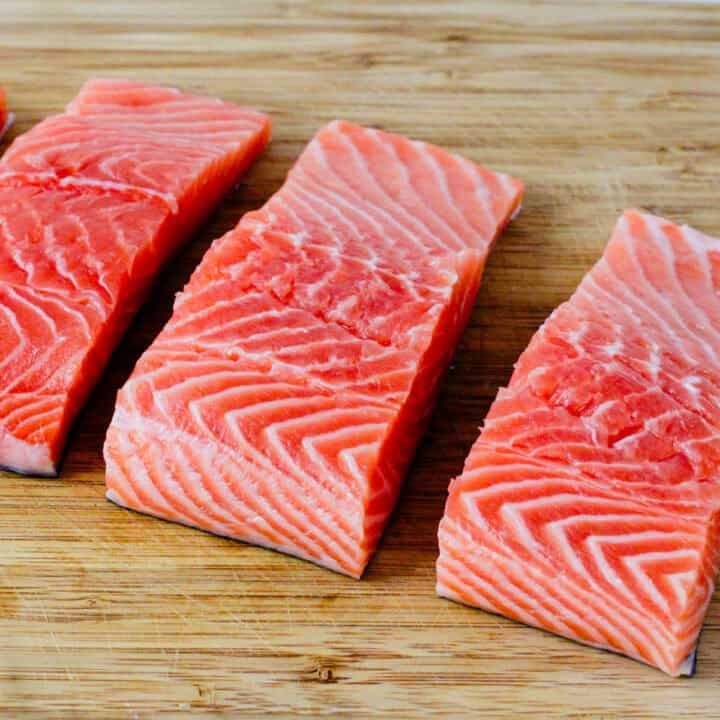 Salmon filets on a cutting board.