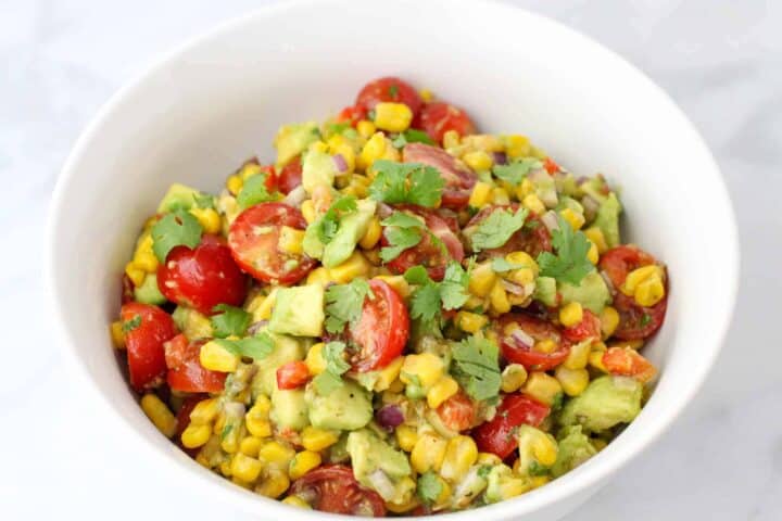 Corn and Avocado Salad served in a white bowl
