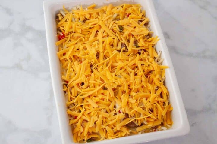 The casserole is shown topped with cheese before baking.
