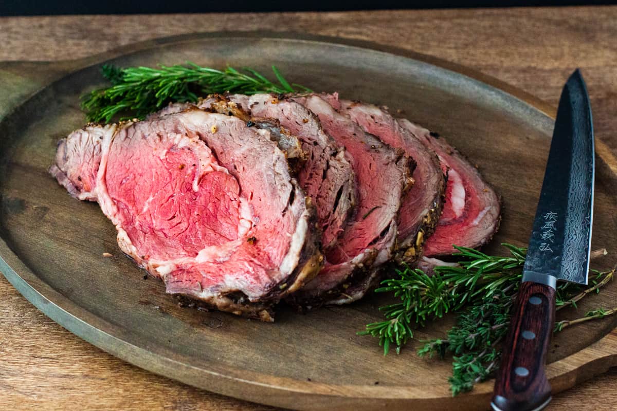 Sliced standing rib roast on a serving platter.