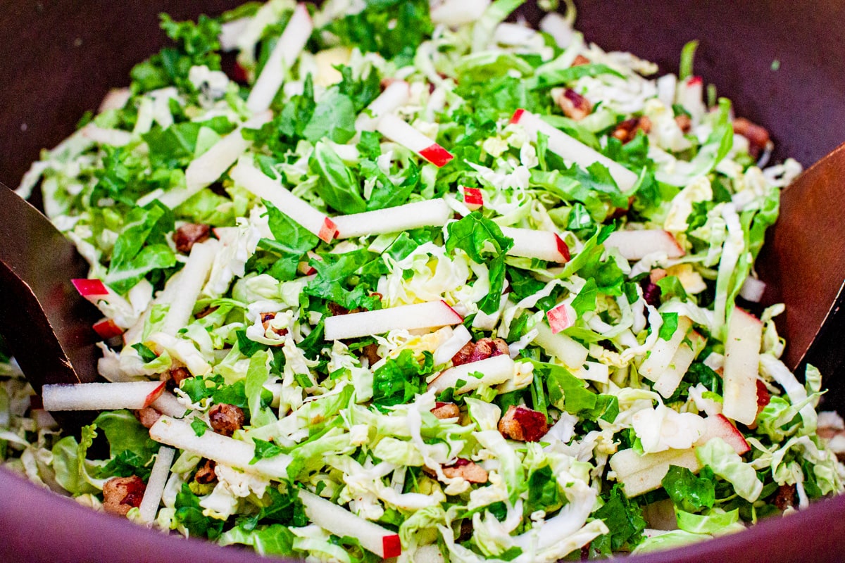 Shaved brussels sprouts and kale salad in a serving bowl.