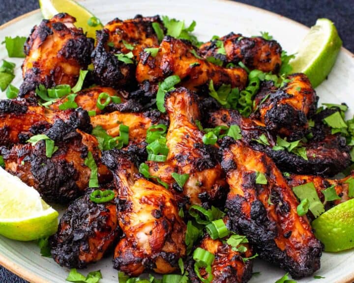 Close up of a plate of grilled chili lime chicken wings 