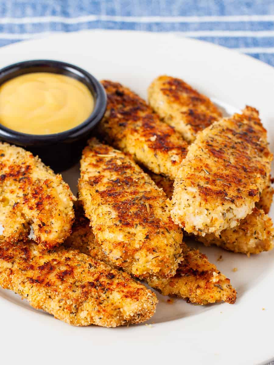 Oven baked chicken fingers on plate.