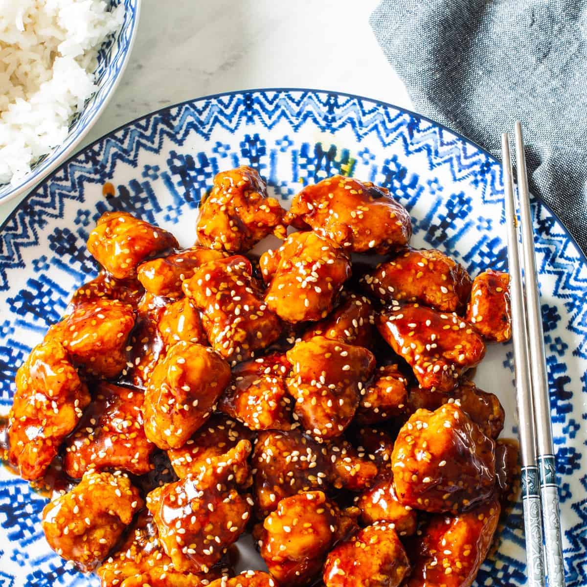 Overhead view of a platter of sesame chicken.