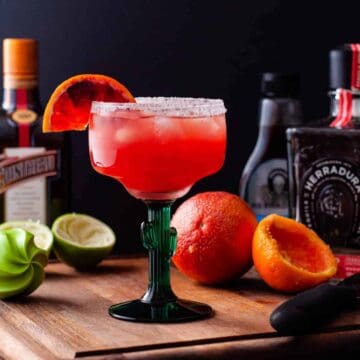 Blood orange margarita served in a sugar rimmed glass