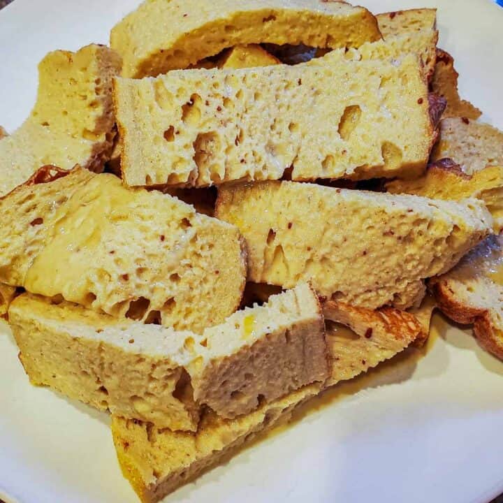 Bread soaked in egg mixture and ready to pan fry