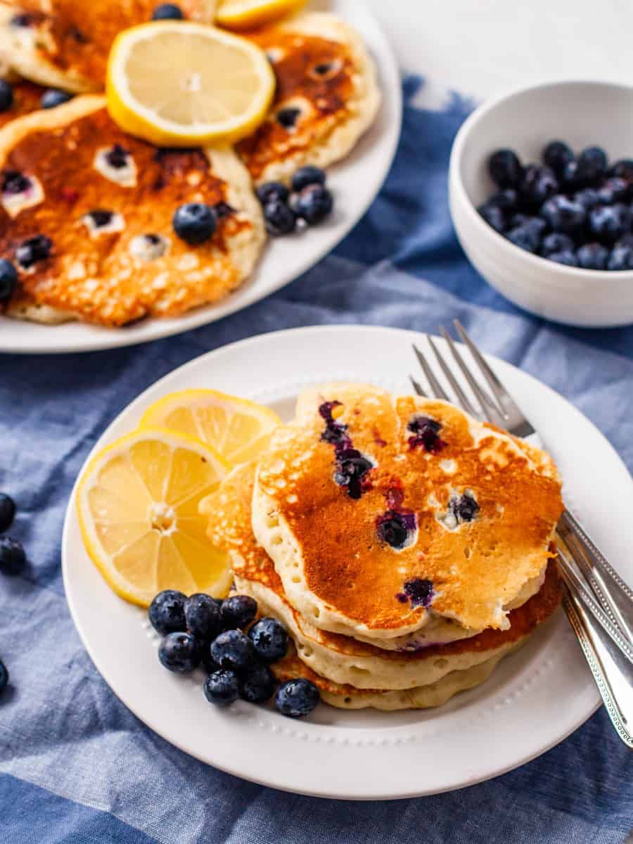 Lemon Blueberry pancakes shown with fresh blueberries