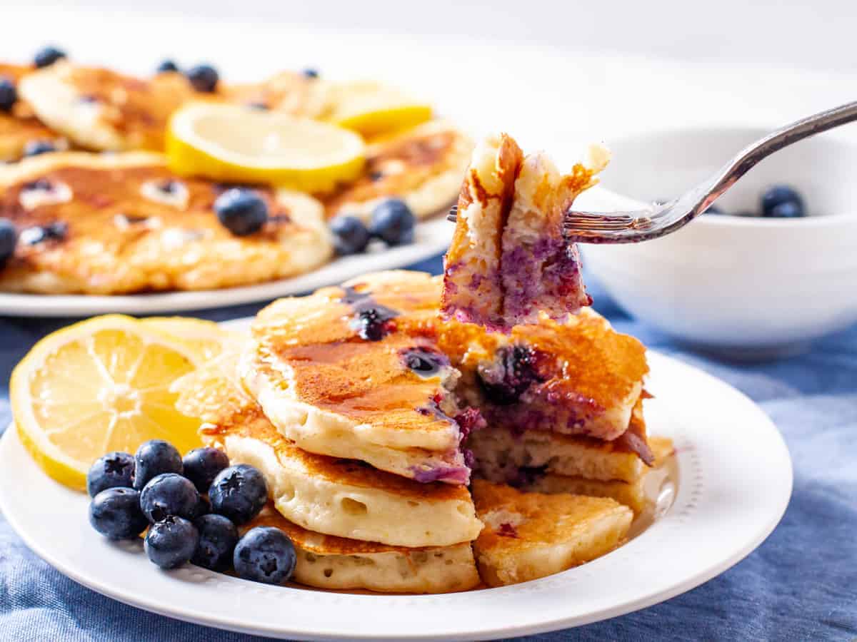 A delicious bite of fluffy lemon and blueberry pancakes 