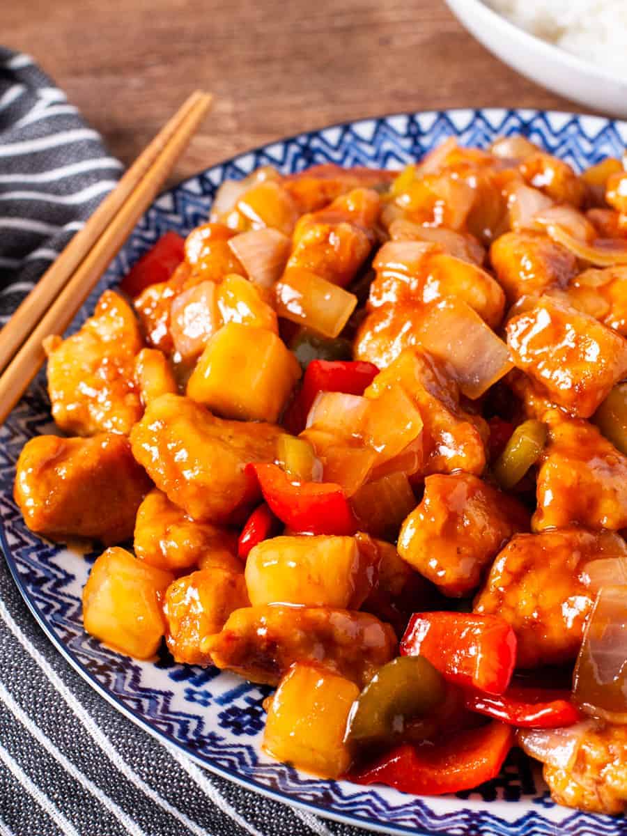 A large platter of crispy sweet and sour chicken served wioth steamed 