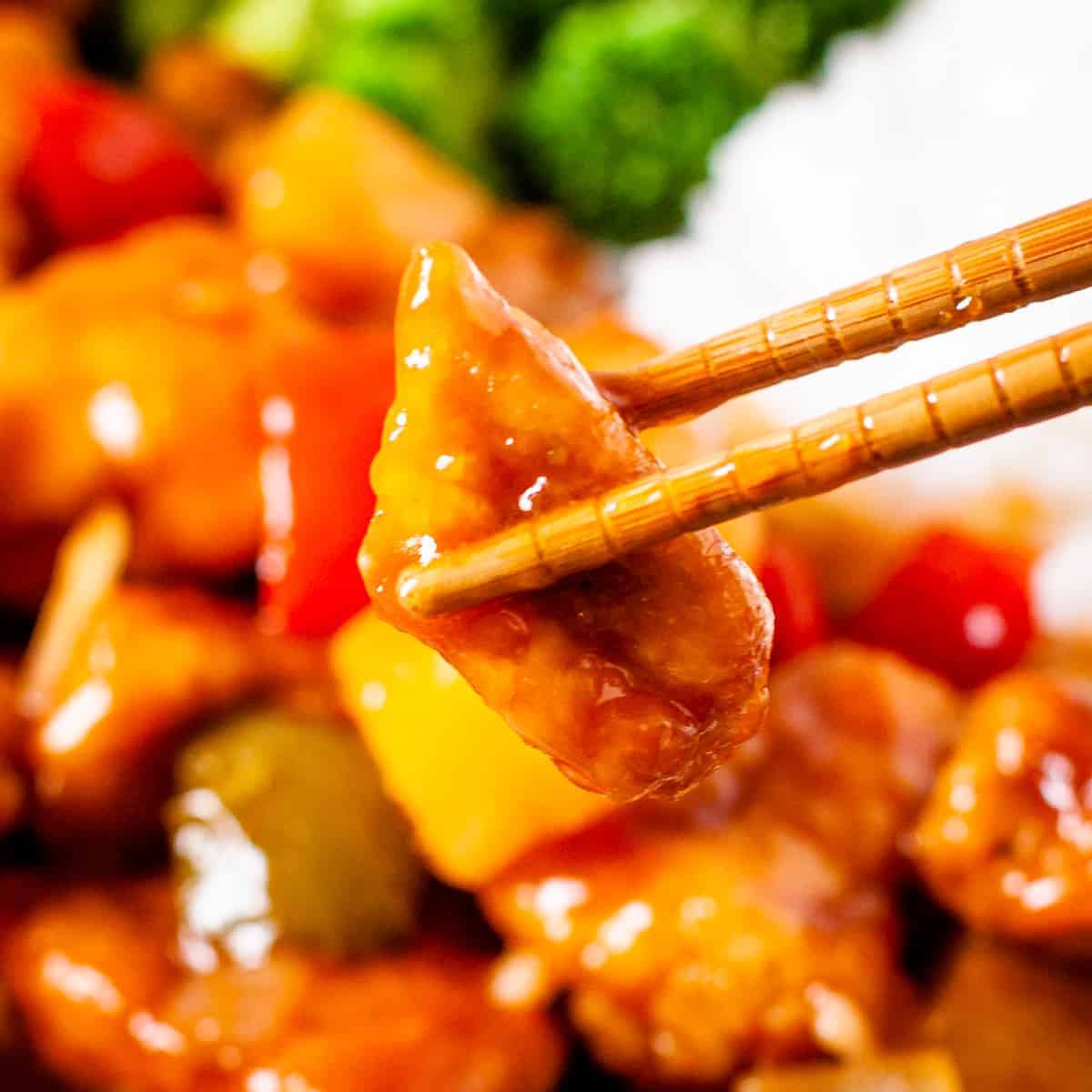Close up shot of a bite of sweet and sour chicken