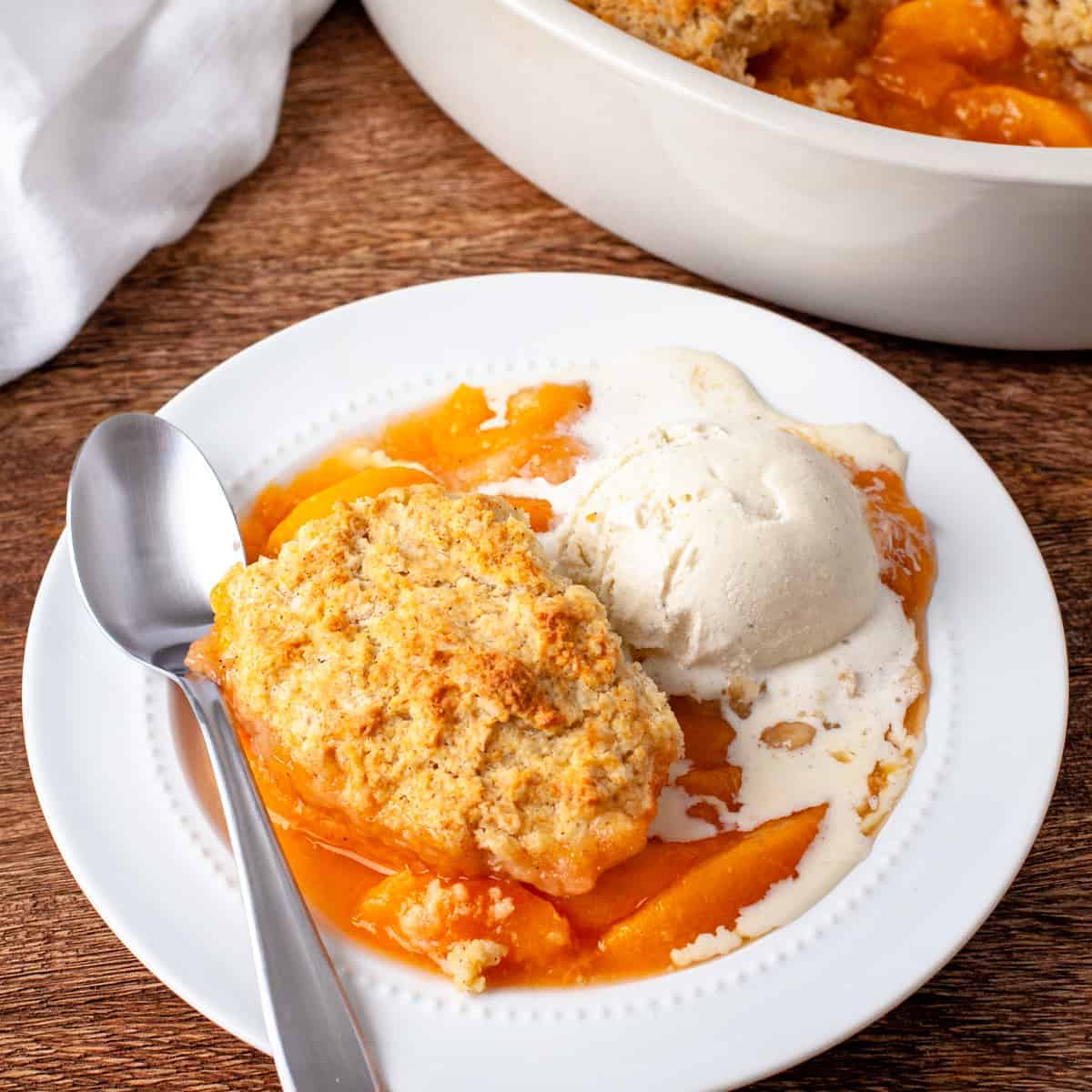 Peach cobbler served witha. scoop of vanilla ice cream