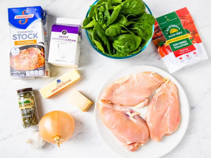 Ingredients for Tuscan chicken shown set on a counter.