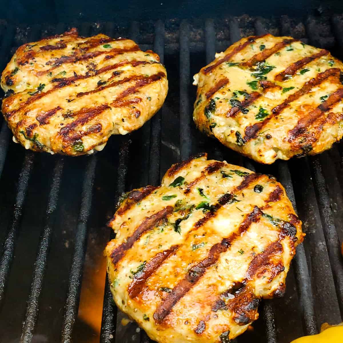 Turkey burgers with spinach and feta on the grill