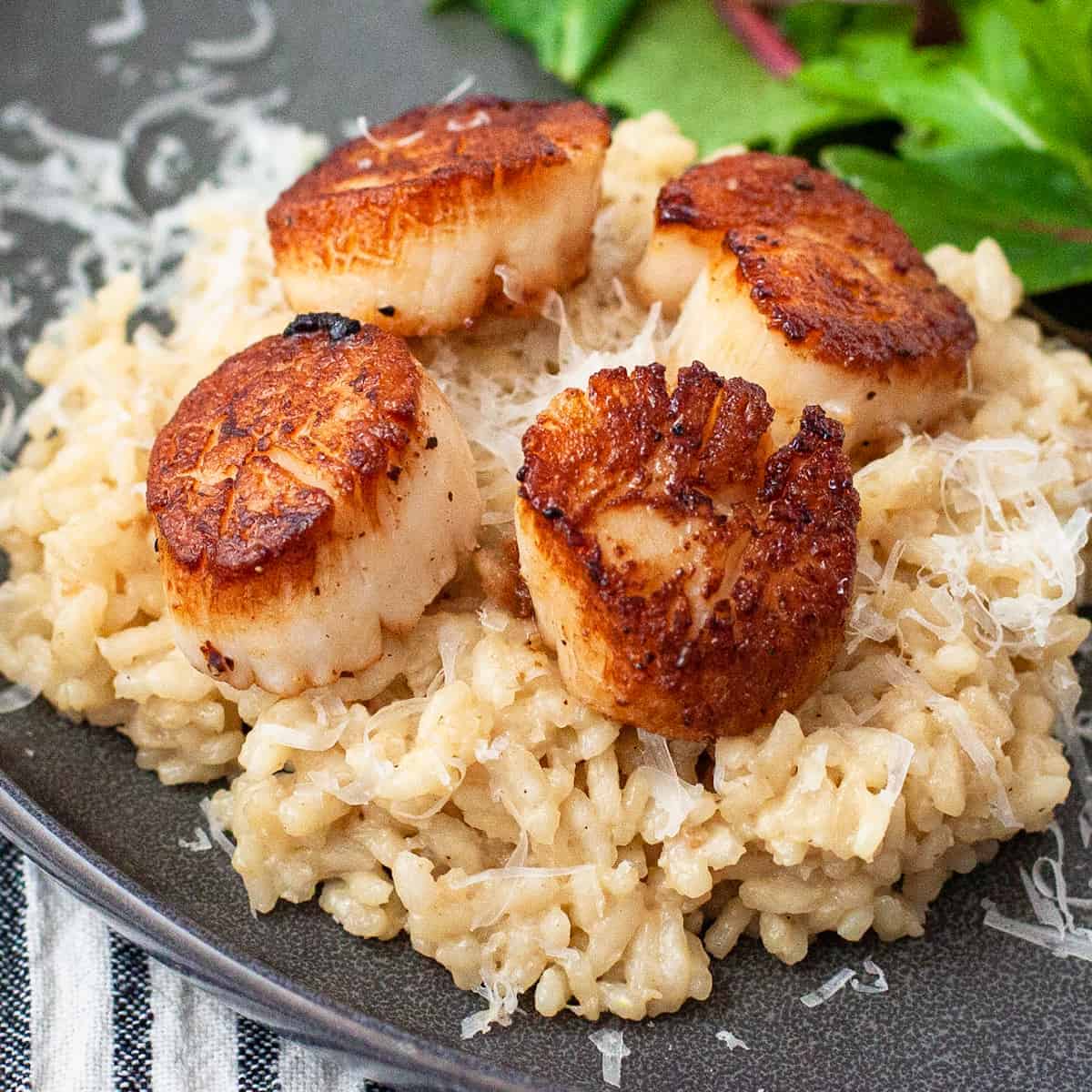 Seared scallops served over a bed of creamy Parmesan risotto.