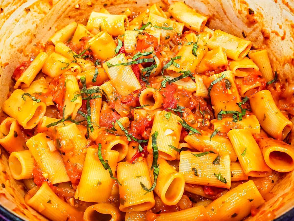 Image of the cooked pasta and sauce in a large dutch oven before serving.