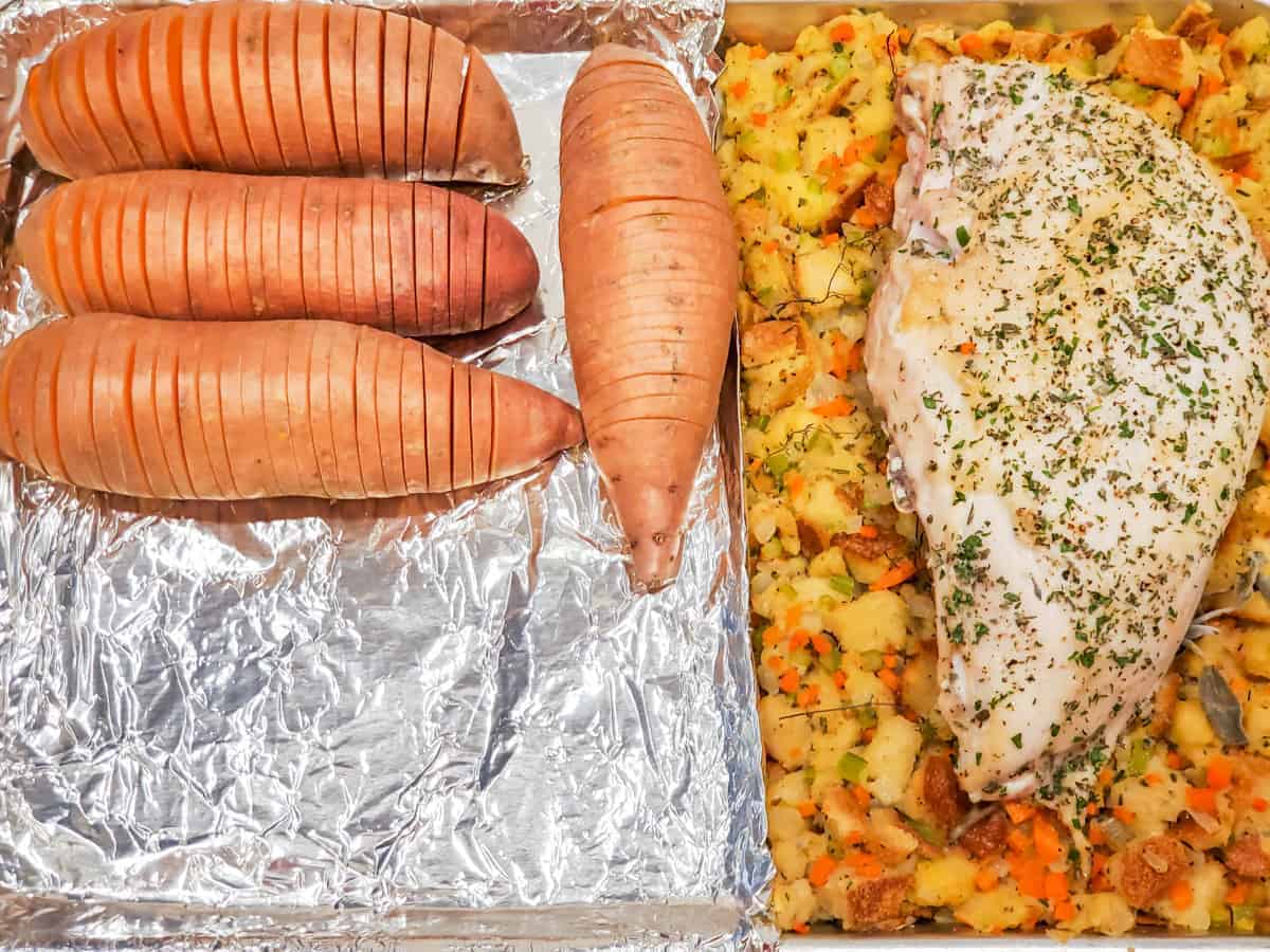 The sheet pan is shown with the cut sweet potatoes alongside the turkey and stuffing.