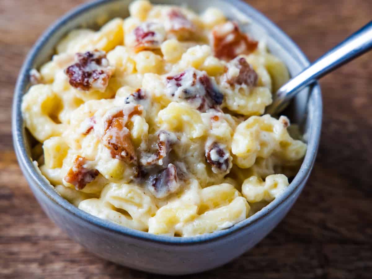 Overhead view of the finished bacon macaroni and cheese served in a small bowl.
