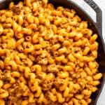 Overhead view of a skillet containing the finished cheeseburger pasta.
