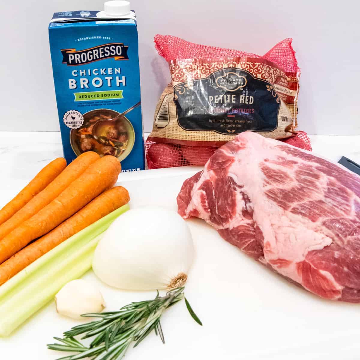 The ingredients for the pork roast are shown set on a counter.