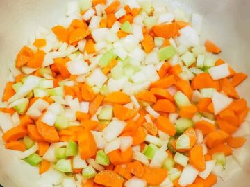 The vegetables are shown being sauteed in a dutch oven until tender.