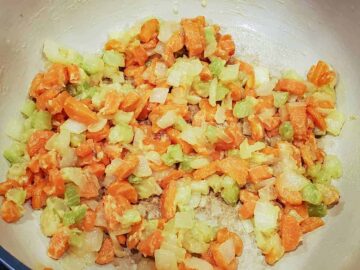Image shows the flour added to the vegetable mixture and then is cooked until light golden brown.