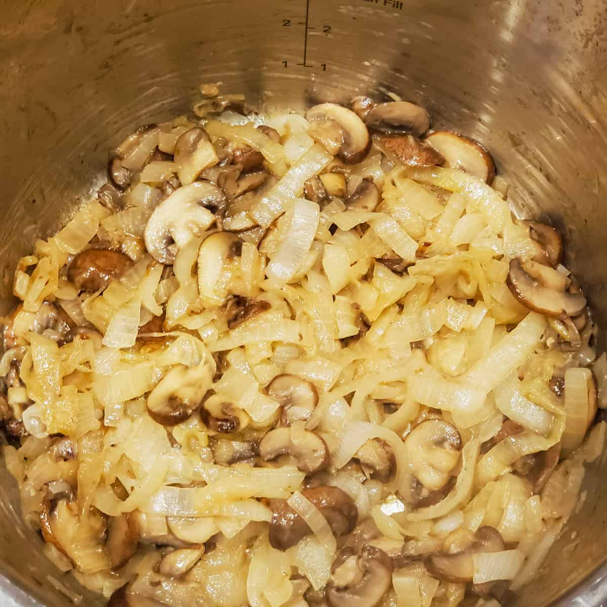 Mushrooms and onions cooking in an Instant Pot.