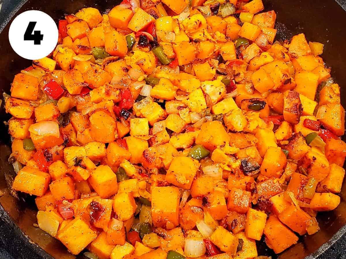 Sweet potato hash shown cooking in a skillet.