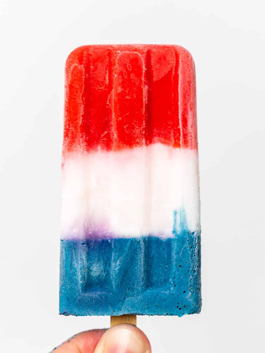 Close up image of a red, white, and blue popsicle.