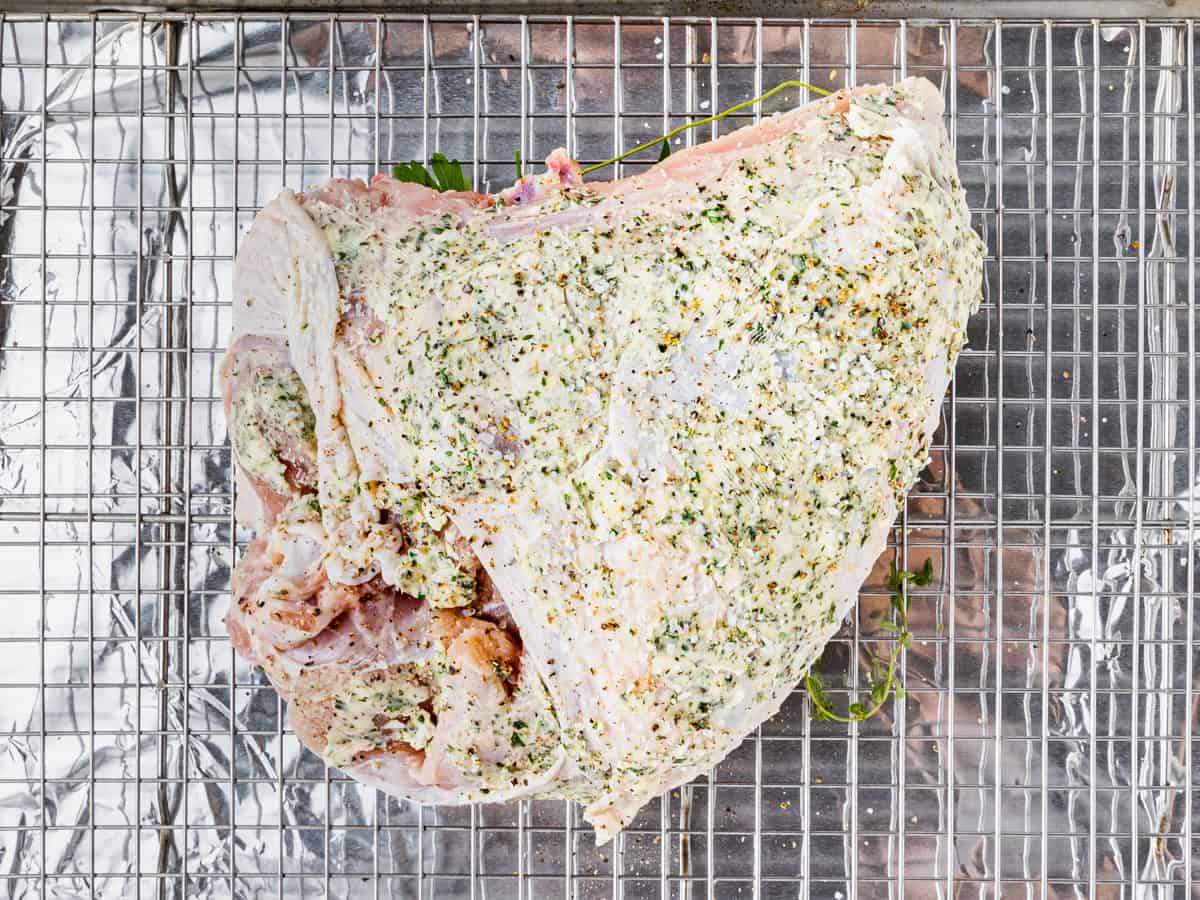 Turkey breast coated in herb butter.