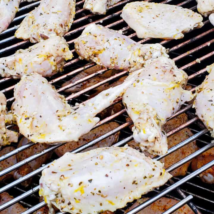 Marinated chicken wings shown on a smoker.