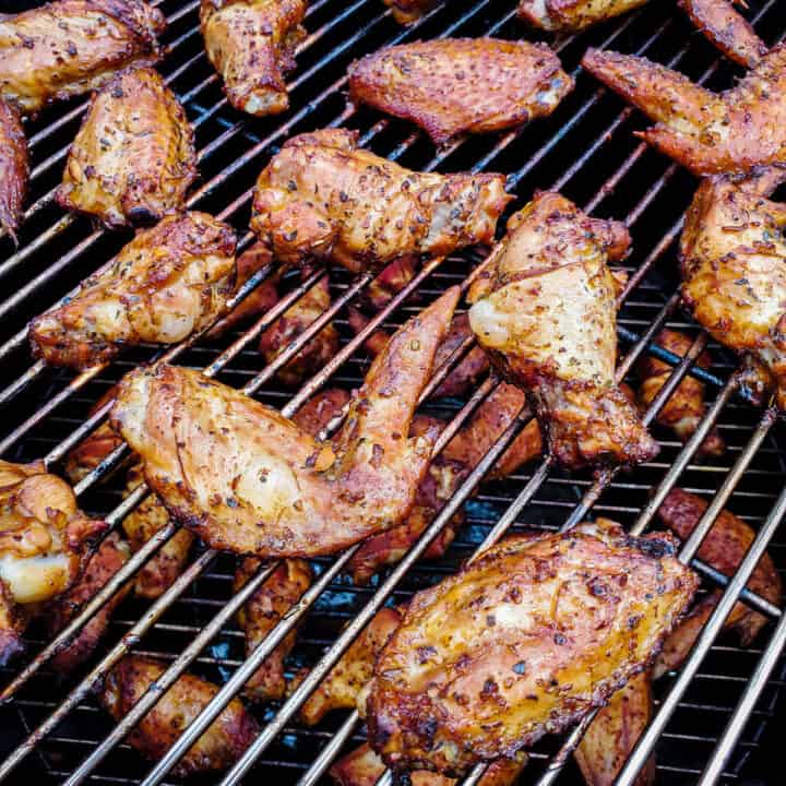 Chicken wings shown on a smoker after being cooked.