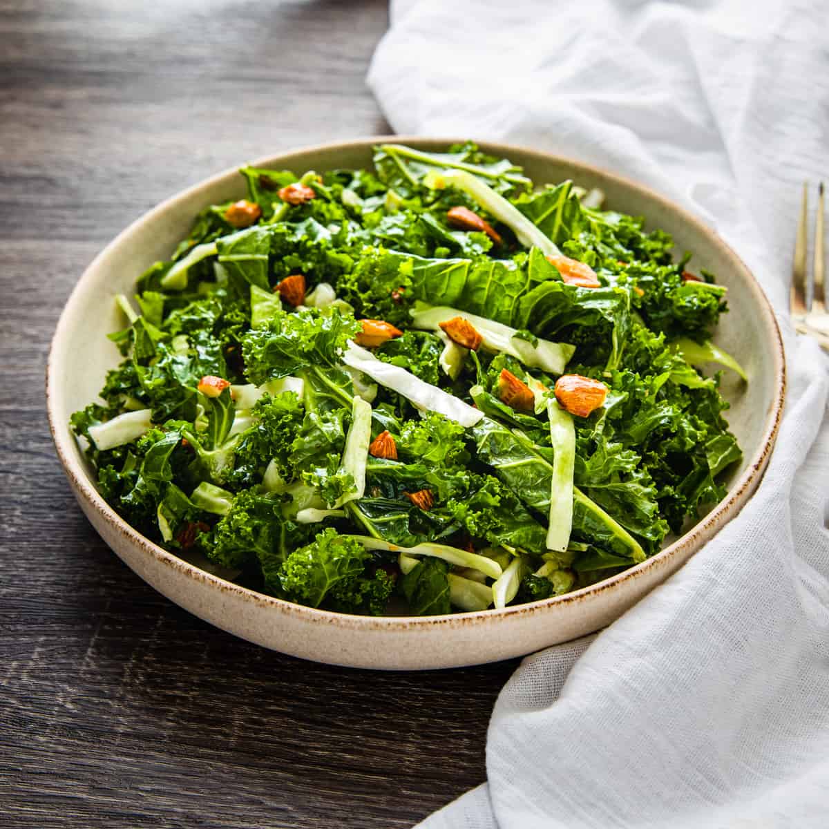 Side angle view of a bowl of kale salad.