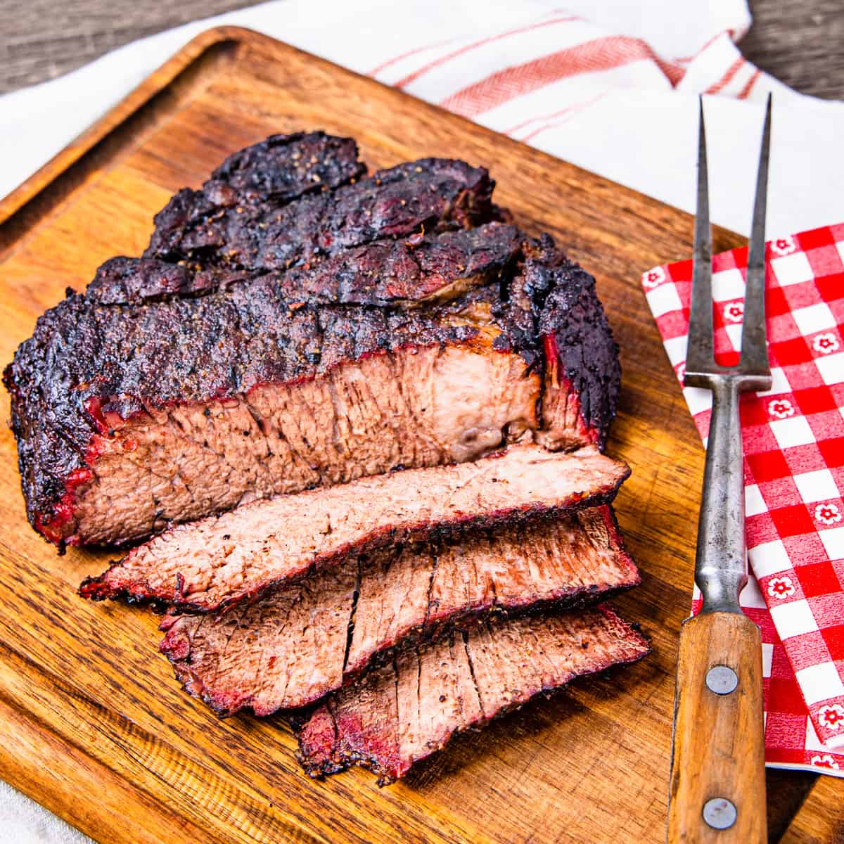 Sliced smoked chuck roast shown on a cutting board.