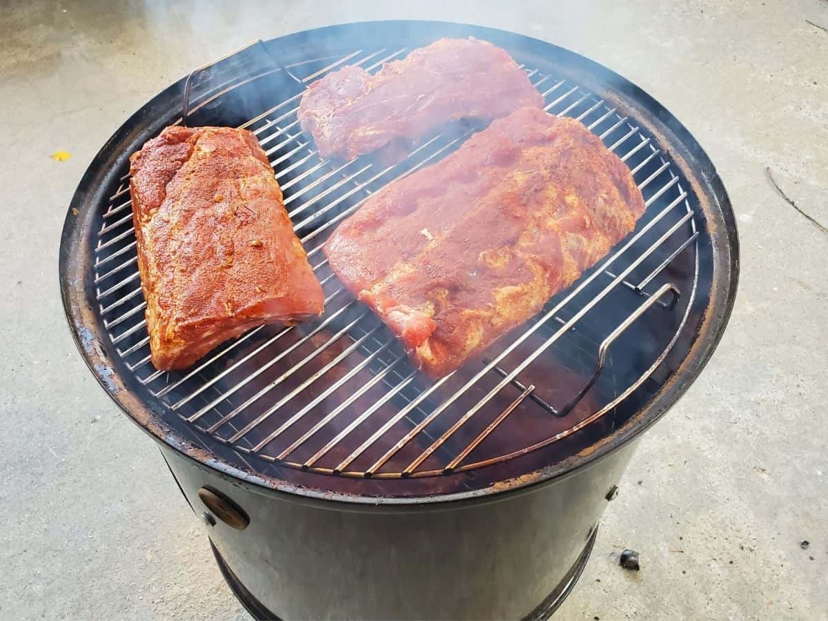 Ribs shown cooking on a drum smoker. 