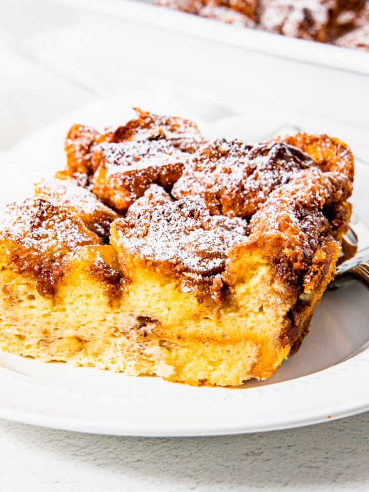 Close up of a slice of brioche French toast casserole on a plate.