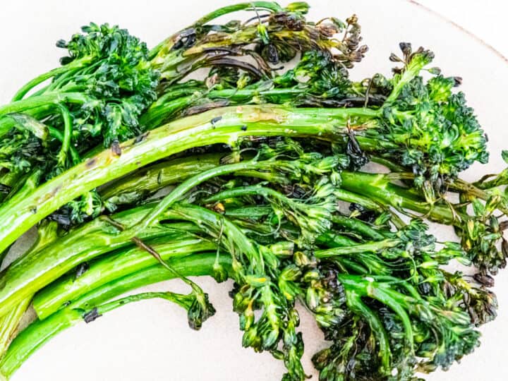 Grilled broccolini served on a plate.