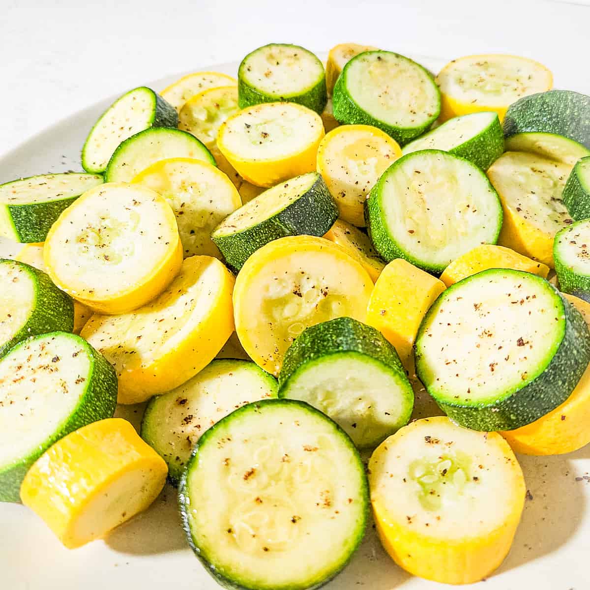 Close up of a platter of grilled squash and zucchini. 