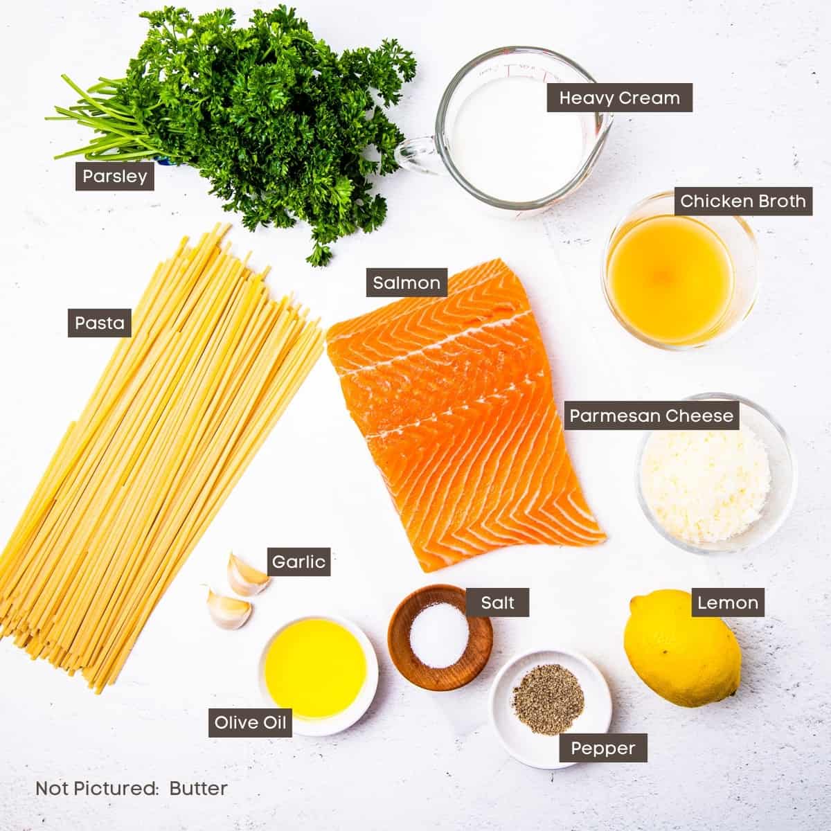 The ingredients for the salmon pasta recipe are shown arranged on a countertop.