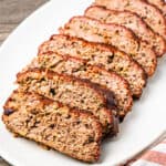 Sliced meatloaf served on a large platter.