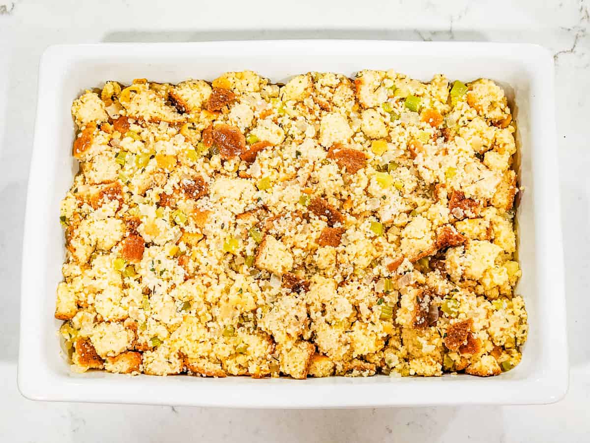 Unbaked cornbread dressing in a large casserole dish. 