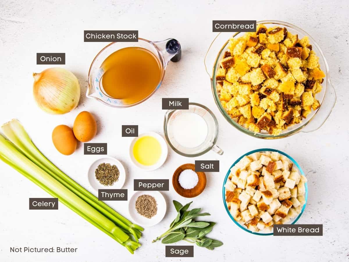 The ingredients for cornbread dressing are shown arranged in bowls on a countertop with labels added for clarity.