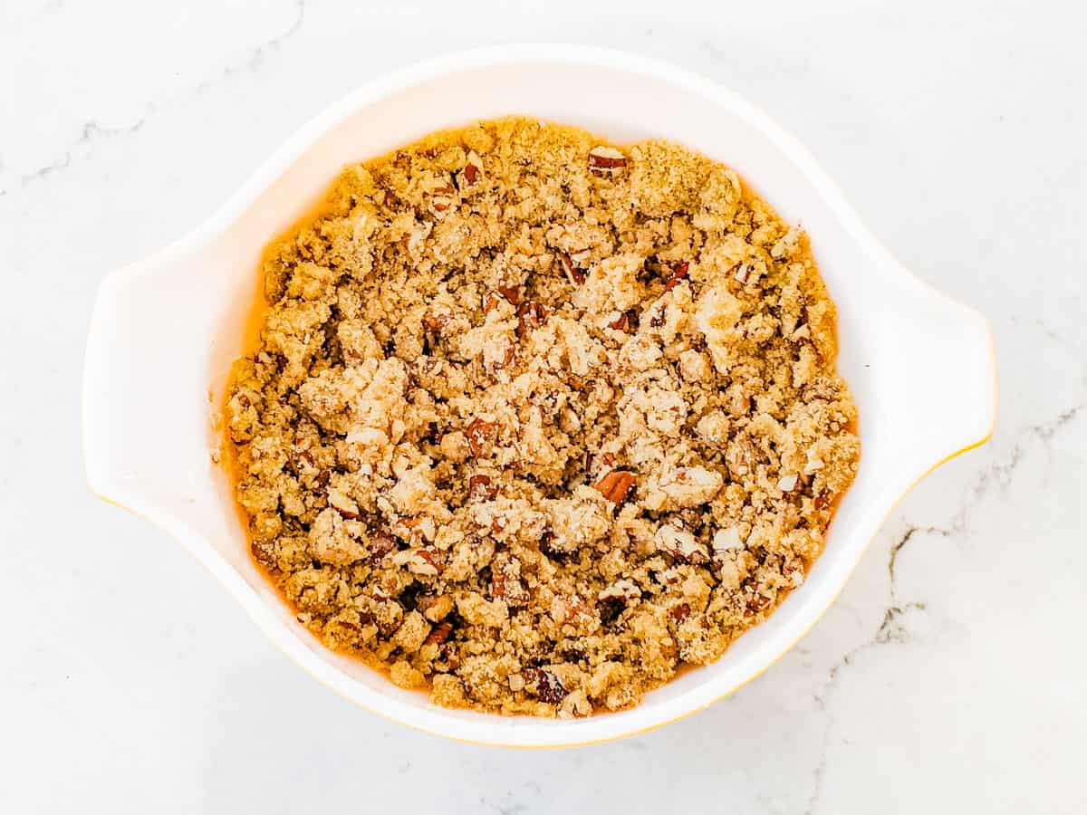 The streusel topping for the casserole shown in a mixing bowl after being stirred together. 