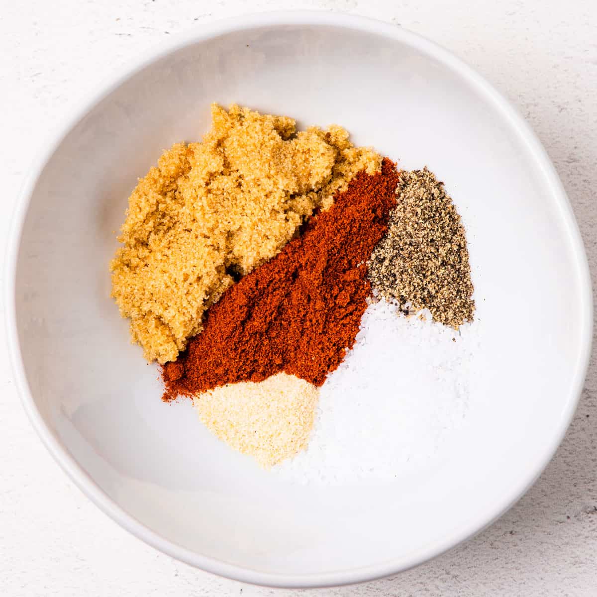 Spices for homemade BBQ rub shown in a small bowl.