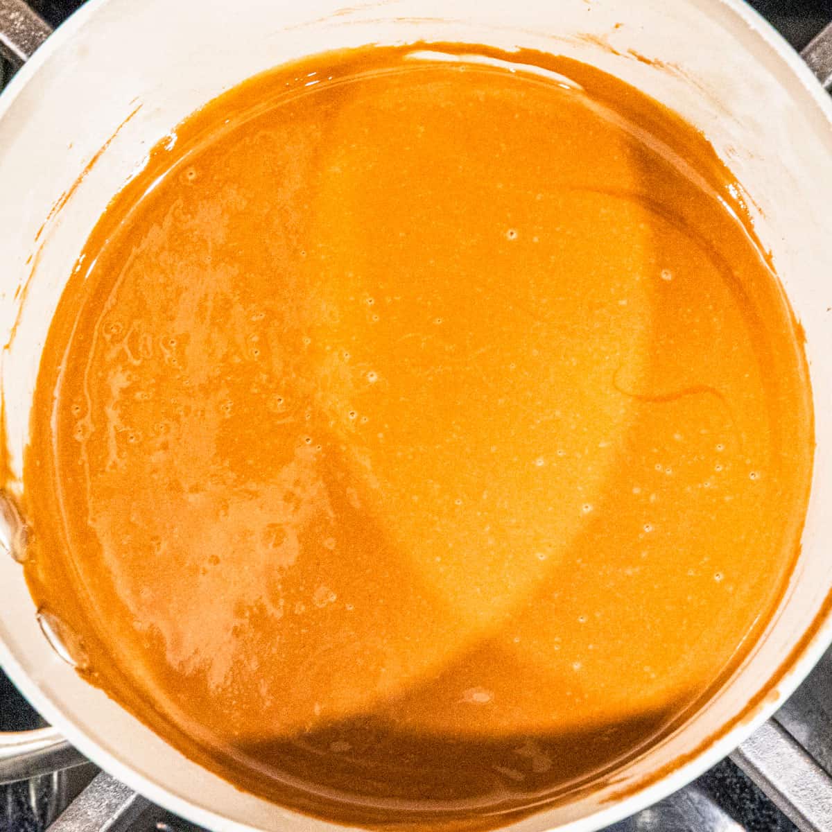 Melted chocolate, butter, vanilla, and peanut butter mixture shown in a pot. 