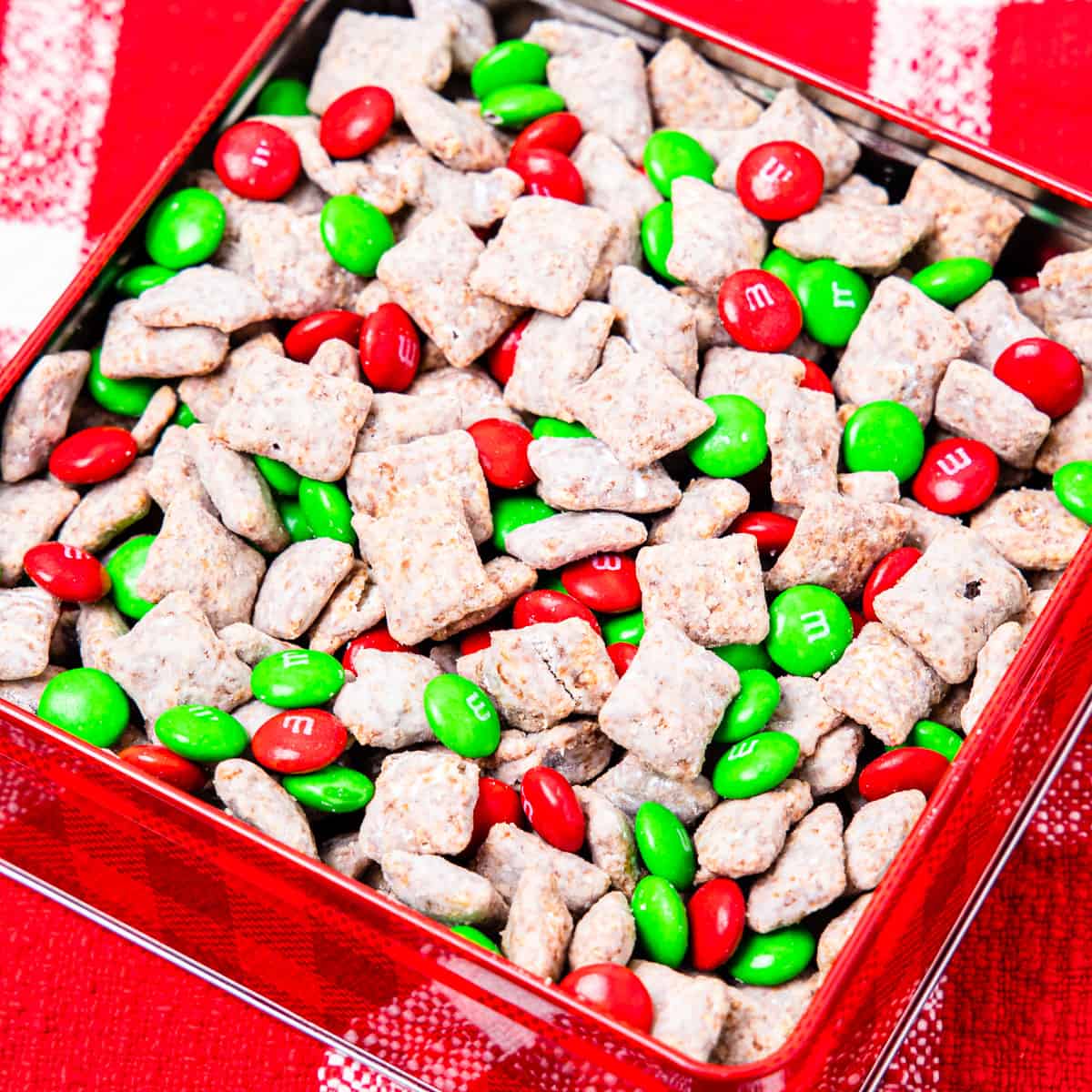 A tin container filled with Christmas puppy chow mix.